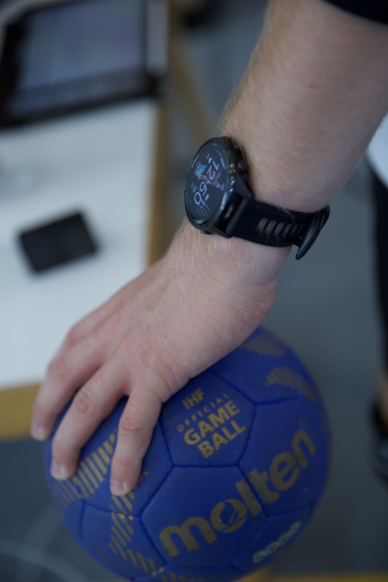 Hand mit Sportuhr am Handball